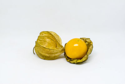 Close-up of yellow slices over white background