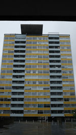 Low angle view of yellow building against sky