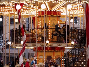 Illuminated carousel in amusement park