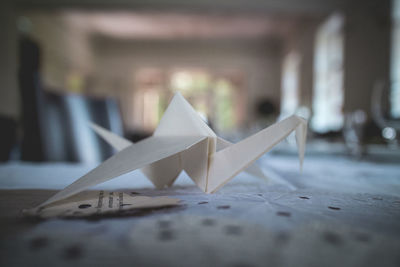 Close-up of paper crane on table