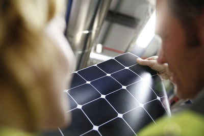 Colleagues examining innovative solar panel