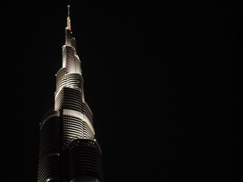 Low angle view of skyscraper at night