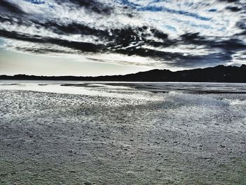Scenic view of beach against sky during sunset