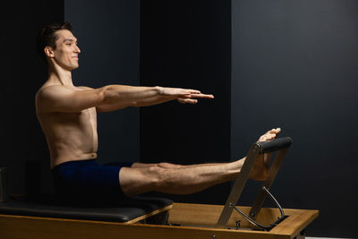 Side view of man exercising in gym