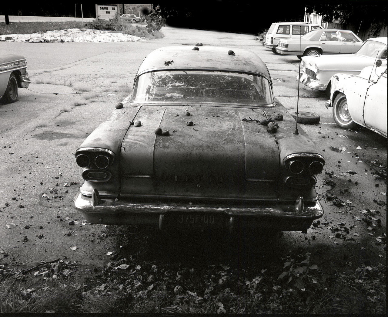 CLOSE-UP OF ABANDONED CAR ON ROAD