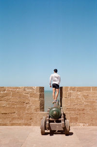 Rear view of man against clear sky