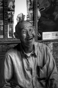 Portrait of a smiling man sitting outdoors