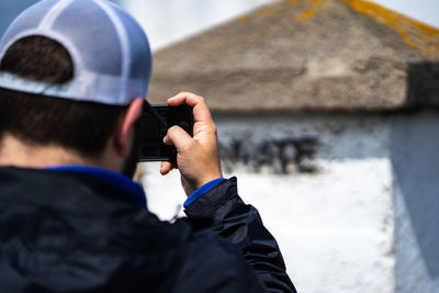 Rear view of man photographing