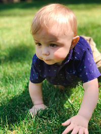 Close-up of baby crawling in grass