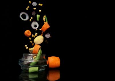 Close-up of candle over black background
