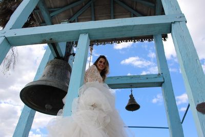 Low angle view of bride in bell tower