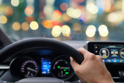 Close-up of person driving car