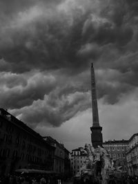 Low angle view of tower against dramatic sky