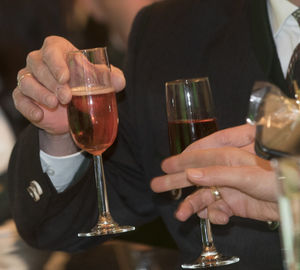 Midsection of woman holding wineglass