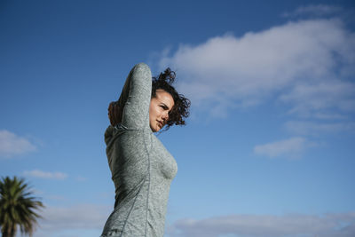 Woman stretching and smiling outside