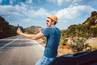 Man standing on road against sky