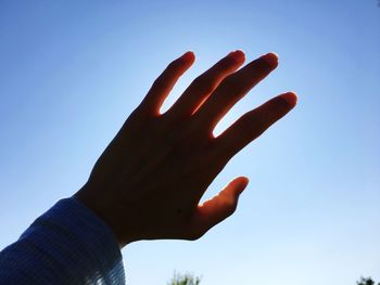 Low angle view of person against clear sky