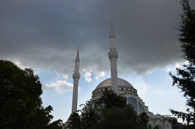 Low angle view of building against cloudy sky