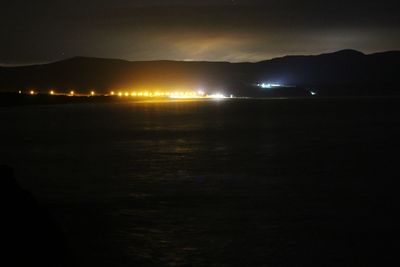 Illuminated mountain against sky at night