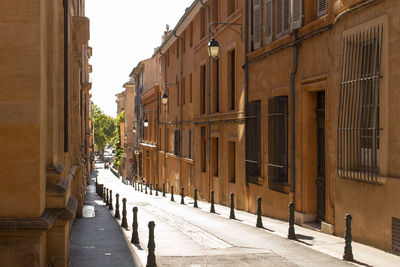 Footpath amidst buildings in city