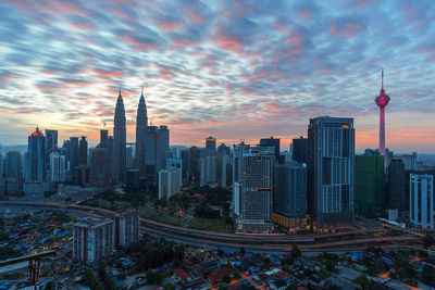 High angle view of cityscape against cloudy sky during sunset