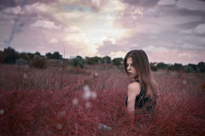 Portrait of woman on field against sky