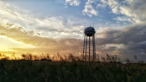 Scenic view of field against cloudy sky