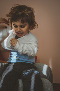 Girl sitting with mother at home