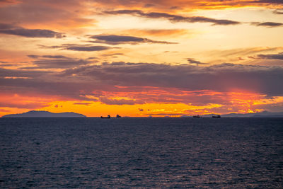 Scenic view of sea against romantic sky at sunset