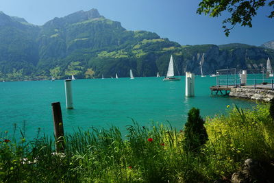 Scenic view of sea and mountains against sky