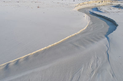 Tire tracks on sand at beach