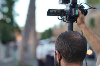 Rear view of man photographing