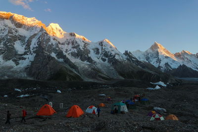 People on mountain against sky