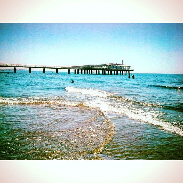 sea, water, horizon over water, clear sky, beach, blue, scenics, copy space, pier, tranquil scene, wave, tranquility, built structure, beauty in nature, shore, nature, surf, idyllic, architecture, ocean