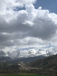 Scenic view of snowcapped mountains against sky