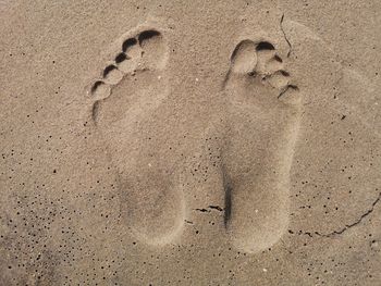 High angle view of footprints on sand