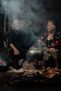 Man preparing food on fire