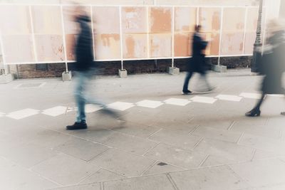 Low section of people walking in corridor