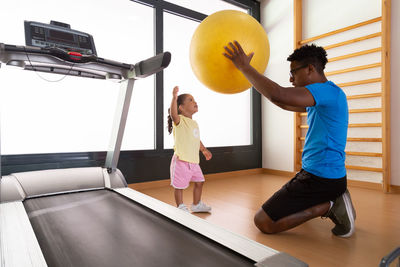 Side view of woman exercising in gym