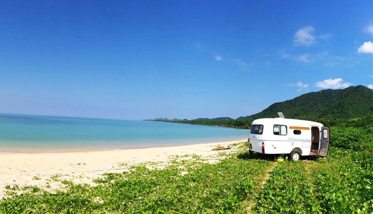 sea, blue, sky, beach, nature, beauty in nature, horizon over water, mode of transport, transportation, outdoors, scenics, tranquility, tree, sand, no people, day, water, motor home