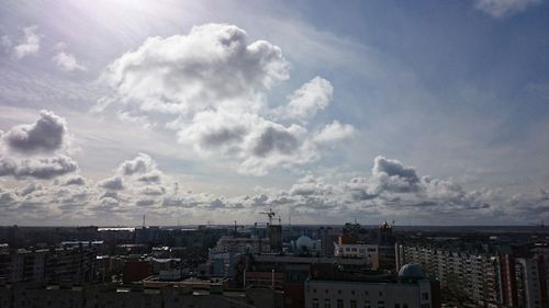 Buildings against cloudy sky