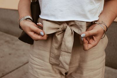 Midsection of woman getting dressed