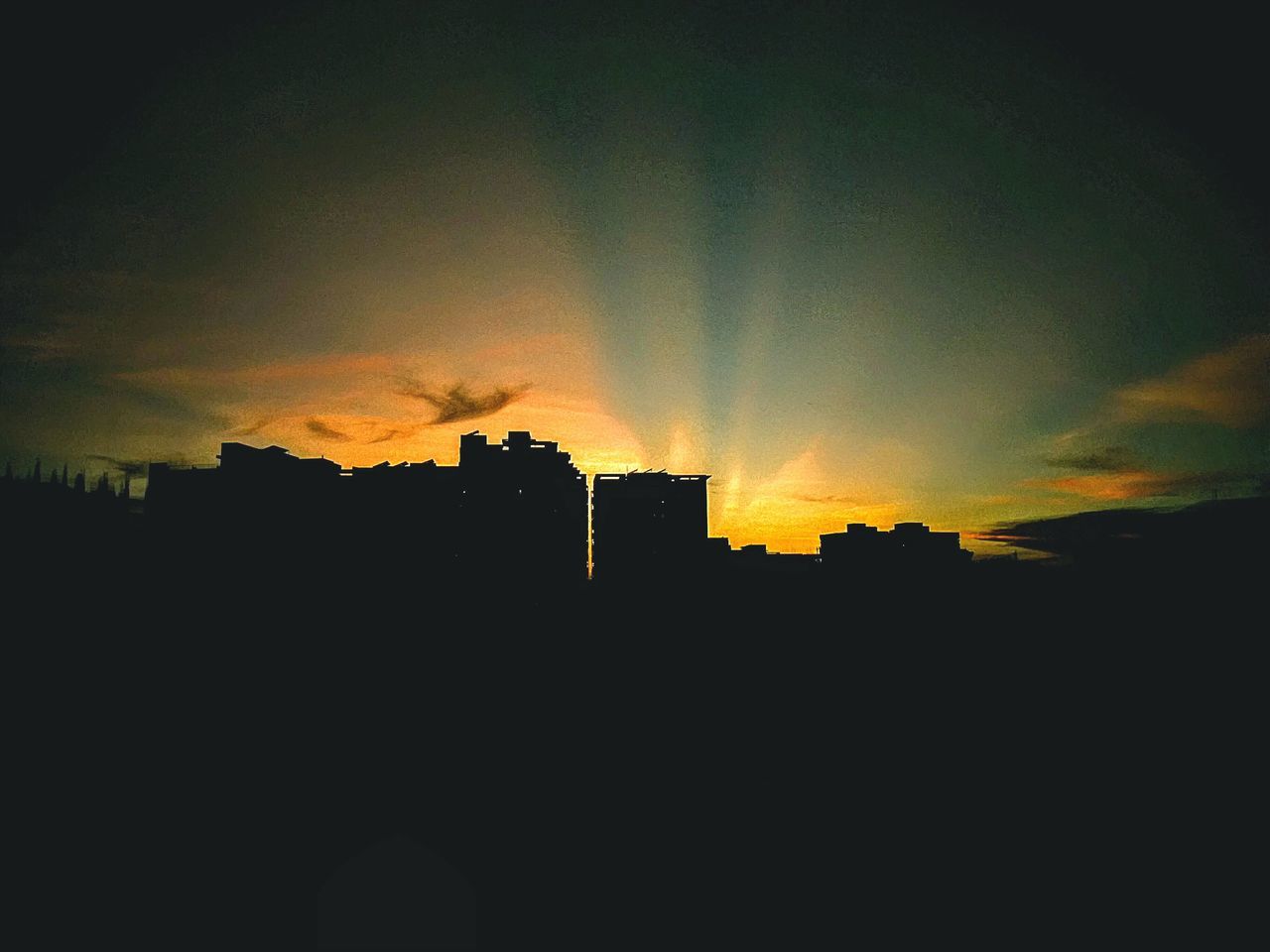 SILHOUETTE BUILDINGS AGAINST SKY AT SUNSET