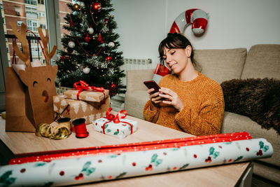 Young woman holding christmas tree