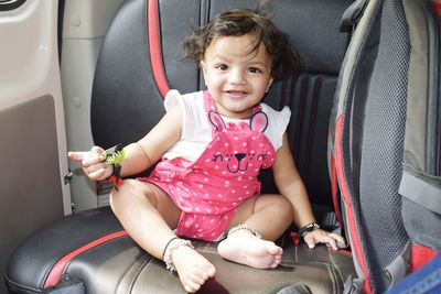 A cute baby in pink and white dress