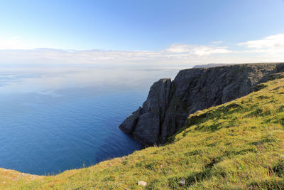 Scenic view of sea and mountains against sky