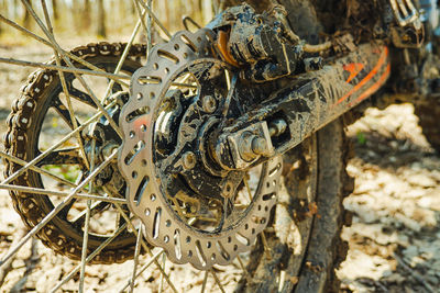 Brake system, hub and drive sprocket with rear motocross bike chain. dirty tires and fork feathers