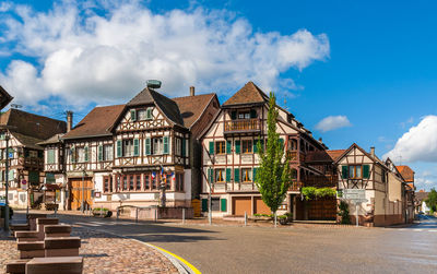 Houses by street in town against sky