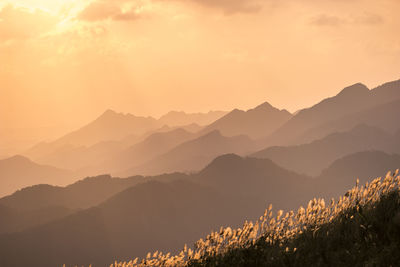 Scenic view of mountains against sky during sunset