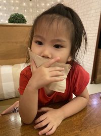 Portrait of cute girl sitting at home